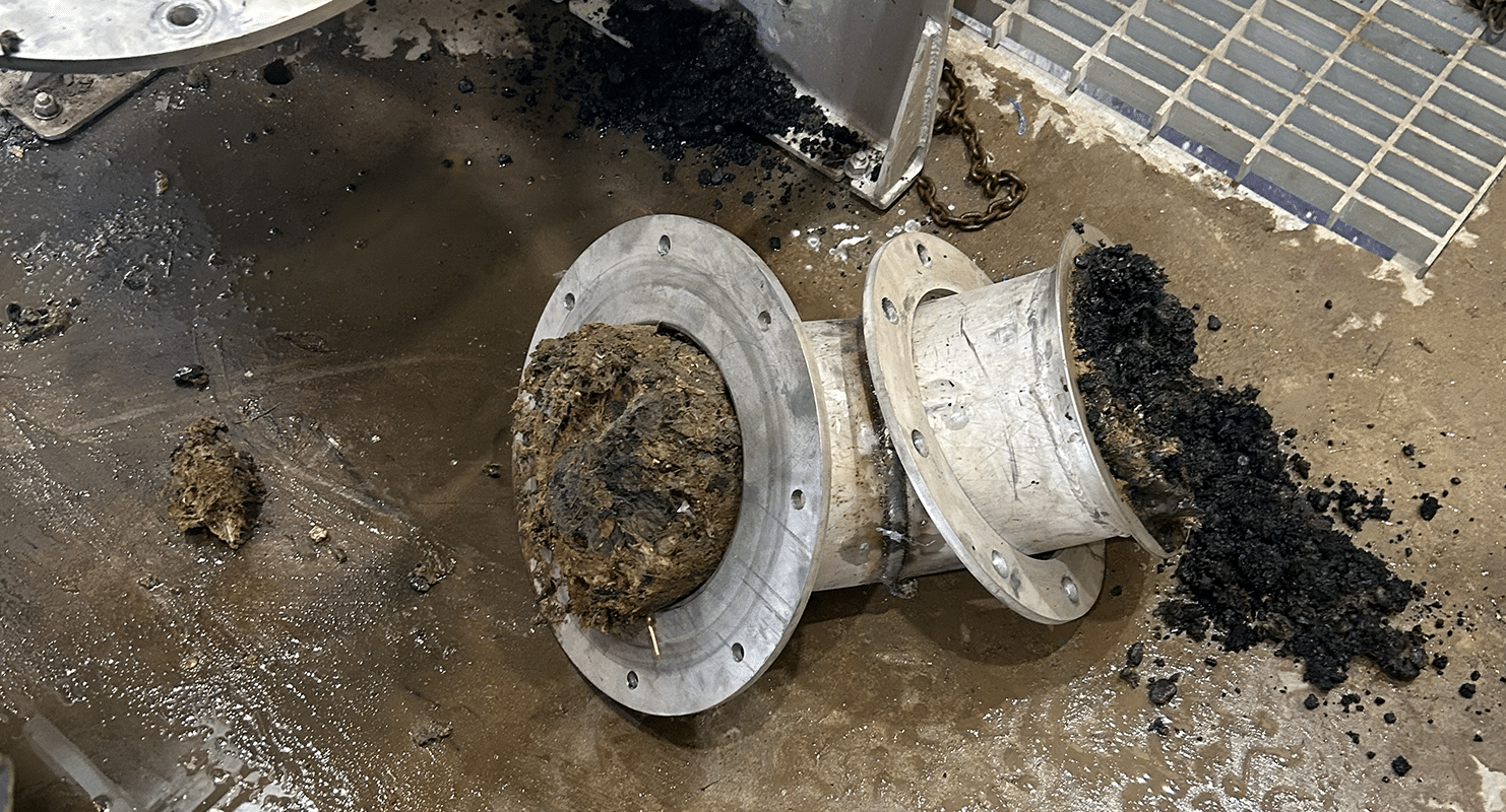 Startup produced an unexpected operational challenge when black, asphalt-like gravel began
arriving at the new screen and clogging the washer/compactor. The source appeared to be asphaltic material entering the sanitary sewer system, likely from equipment washout. Although the condition was outside the project’s design assumptions, the new screen captured the material rather than allowing it to pass downstream, highlighting the value of improved front-end screening.